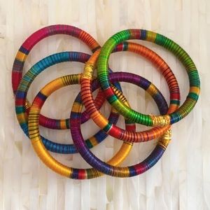 Assortment of six silk stackable bracelets.